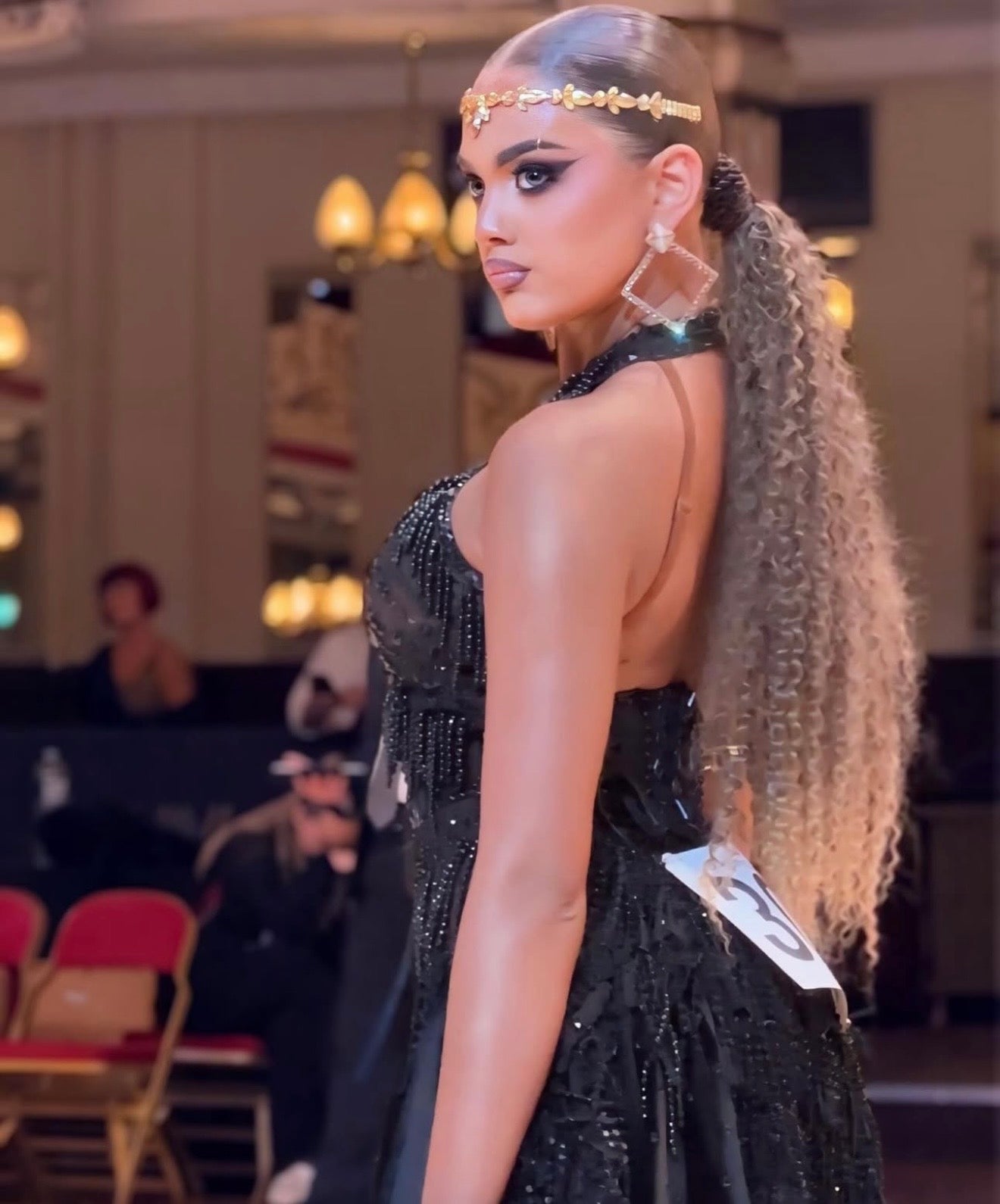 Latin dancer in black dress with earrings and headband